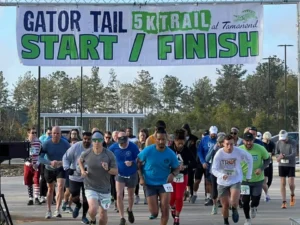 Runners leaving the Gator Tail 5K Trail start line at Tamanend